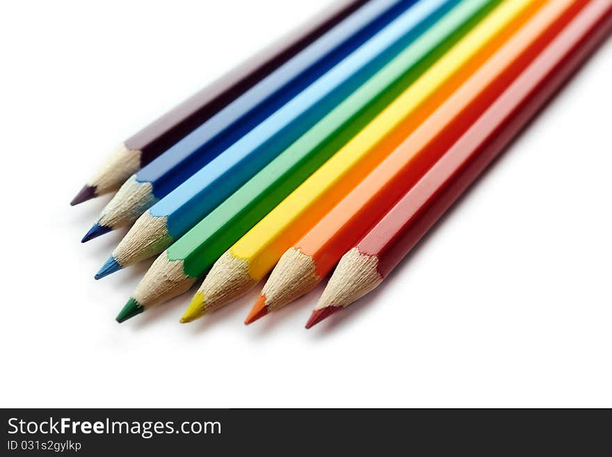 Color pencils arranged in rainbow spectrum order isolated on white background