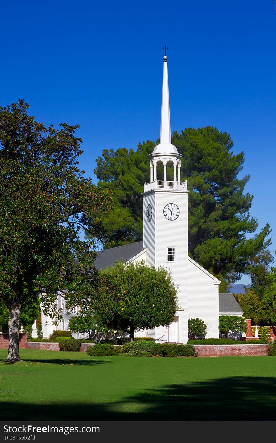 Small church with steeple set in pastoral setting. Small church with steeple set in pastoral setting.