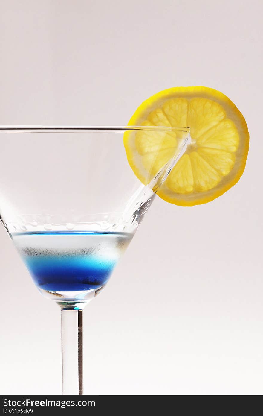 Blue cocktail with yellow lemon