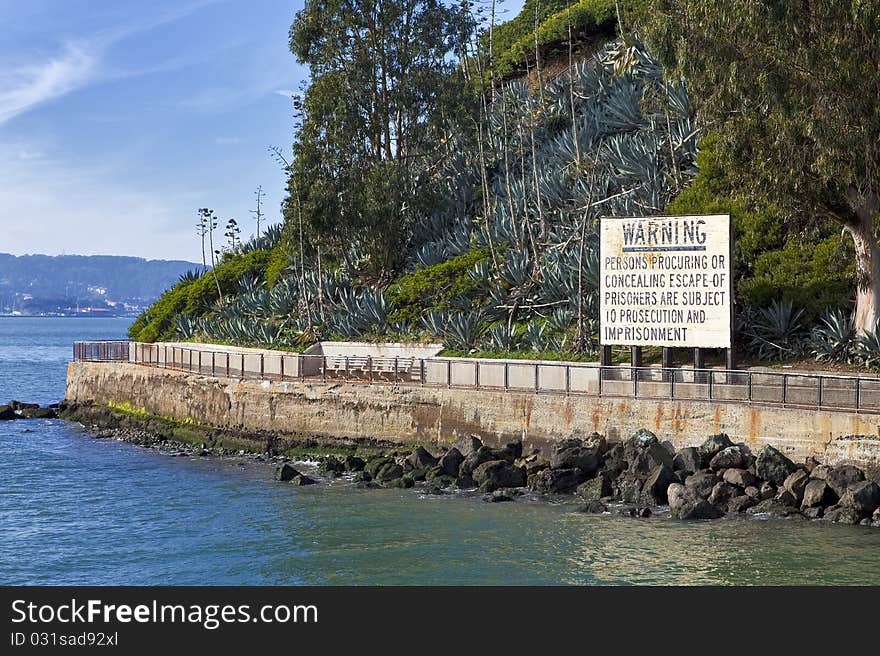 A warning sign on a sea wall. A warning sign on a sea wall