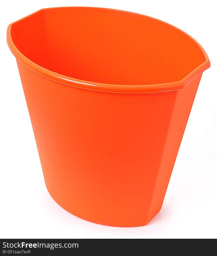 Small orange plastic garbage bin over white background. Clean unused.