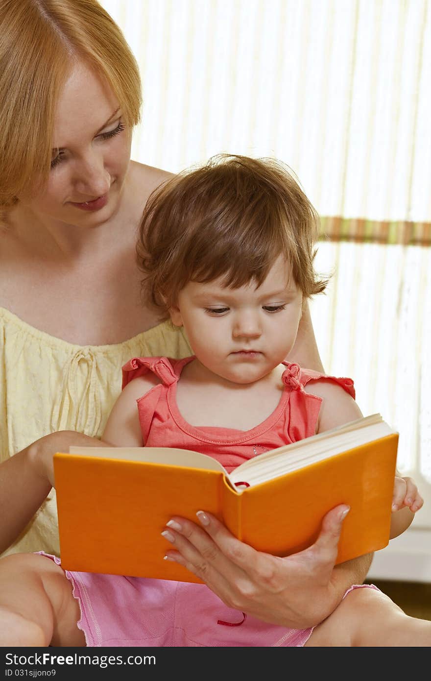 Mother With Her Daughter Reading Book