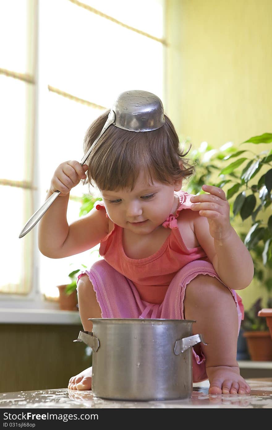 Little Girl With A Pan And Ladle On Her Head