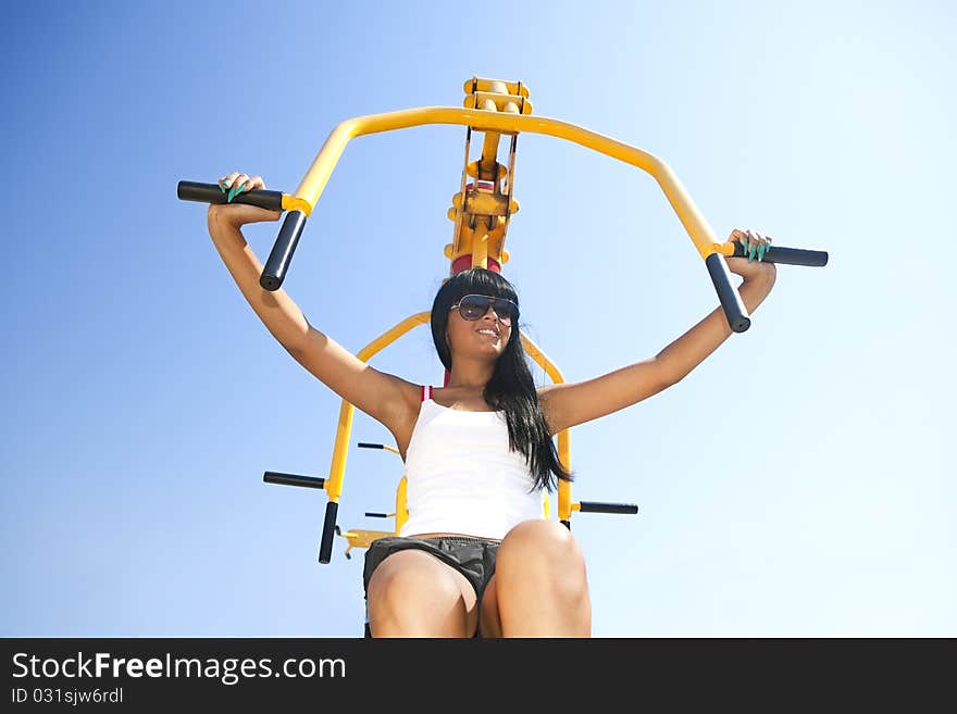 Model working out on fitness playground