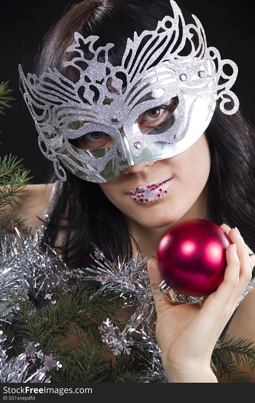 Girl In Mask Holds A Red Sphere