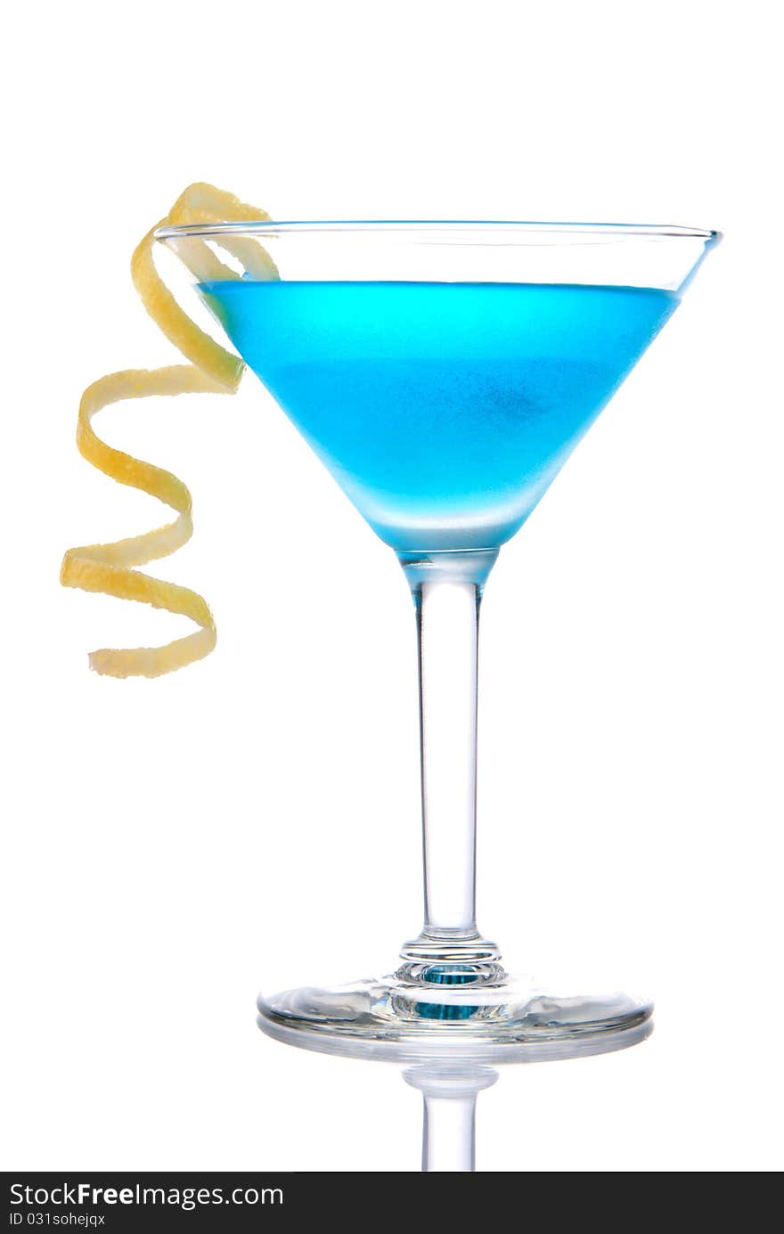 Blue tropical cocktail with lemon spiral isolated on a white background