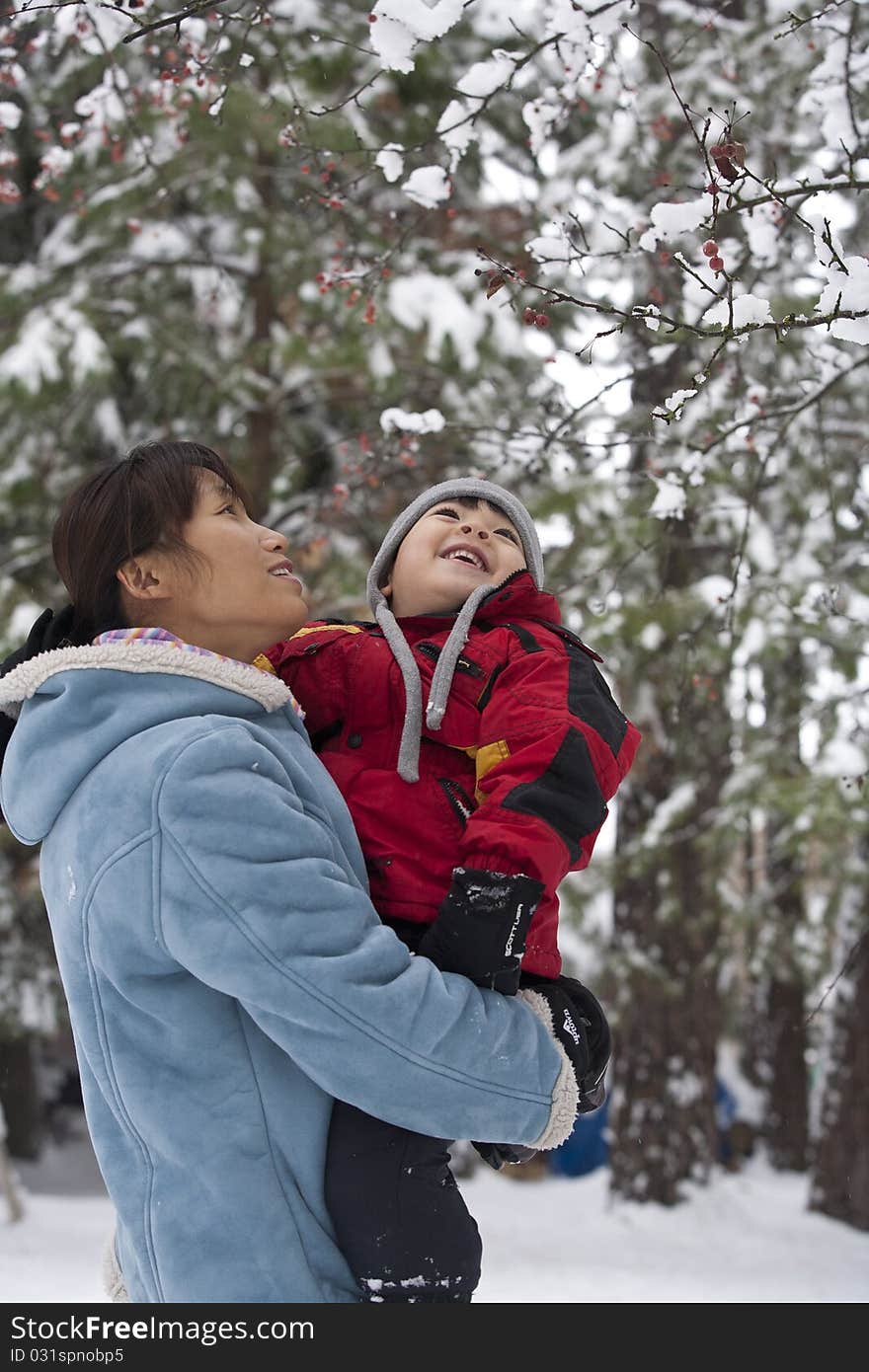 Mother And Son Look At Snow.