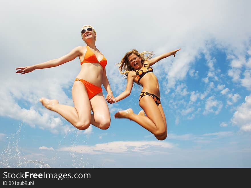 Happy friends jumping an outdoors