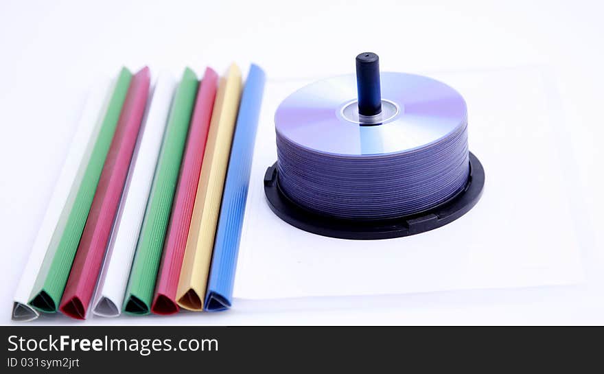 Colorful paper clips and a stack of CD-ROM. Colorful paper clips and a stack of CD-ROM