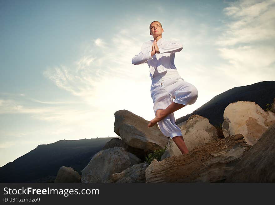 Beautiful young woman doing yoga exercise