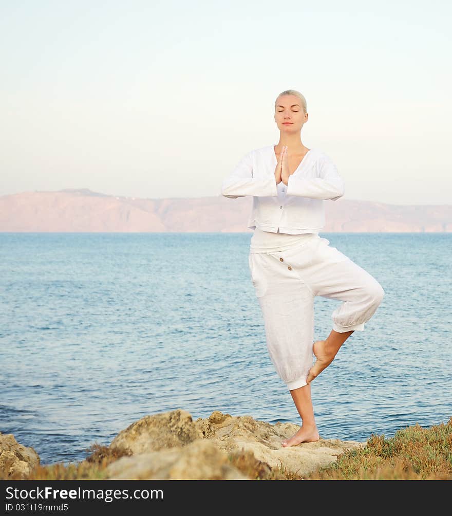 Beautiful young woman doing yoga exercise