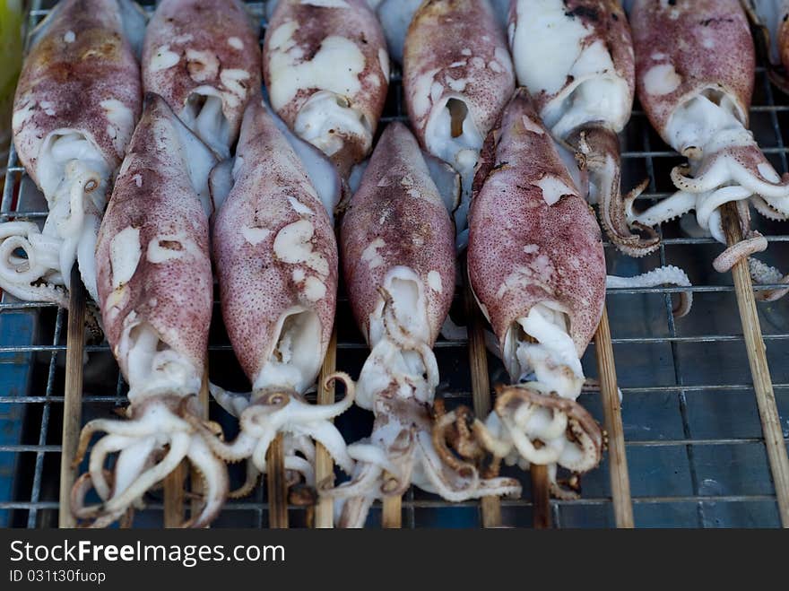 Grilled squids sold in a Thai market