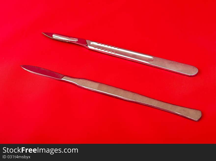 Scalpel on a red background