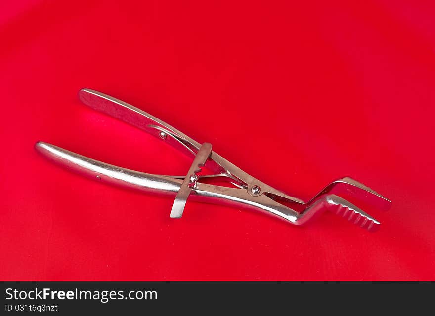 Surgical instrument on a red background