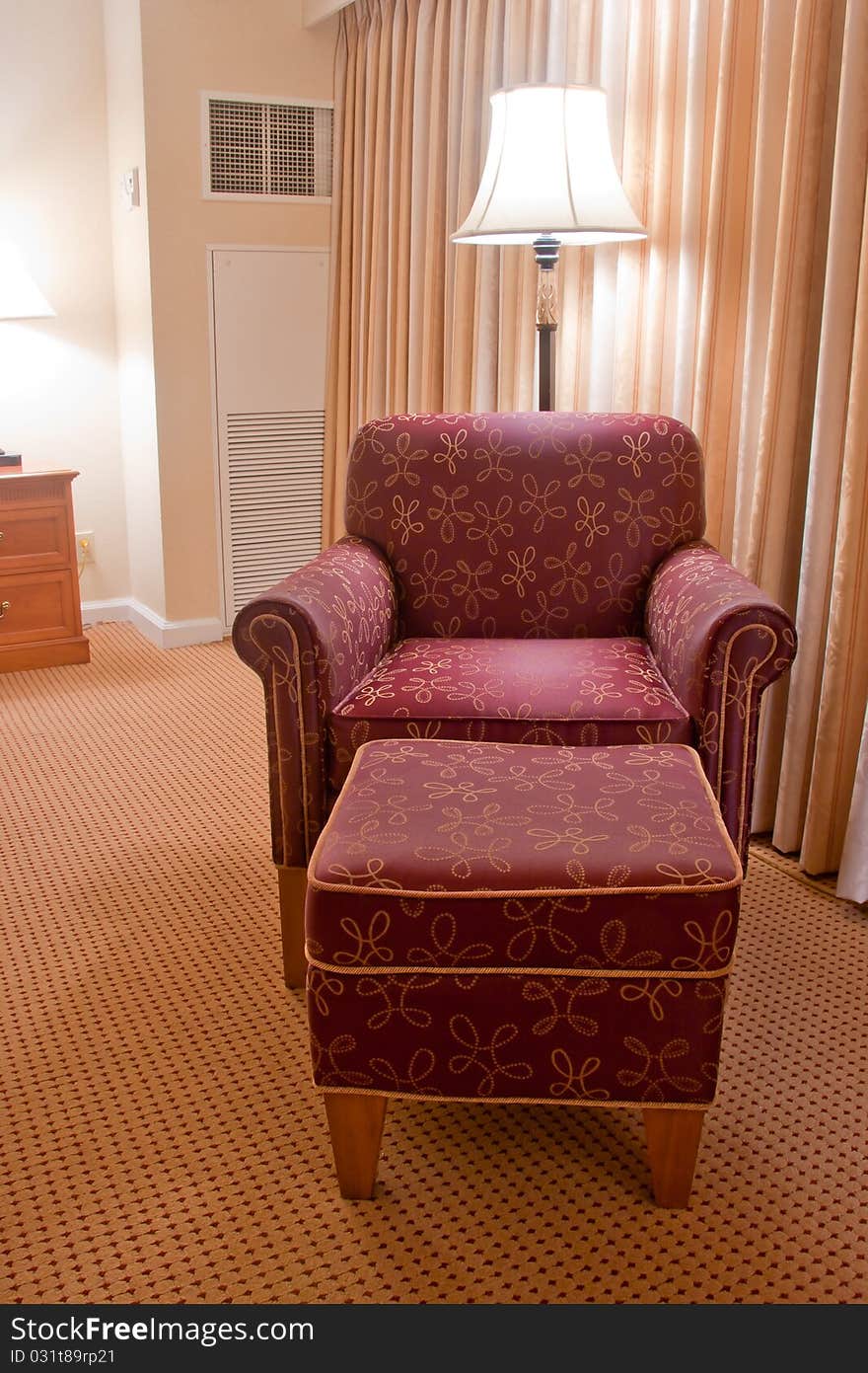 Elegant Red Armchair And Pouffe On Carpet