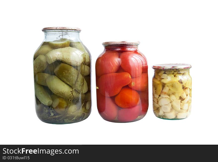 Tinned cucumbers, tomatoes and mushrooms on a white background. Tinned cucumbers, tomatoes and mushrooms on a white background