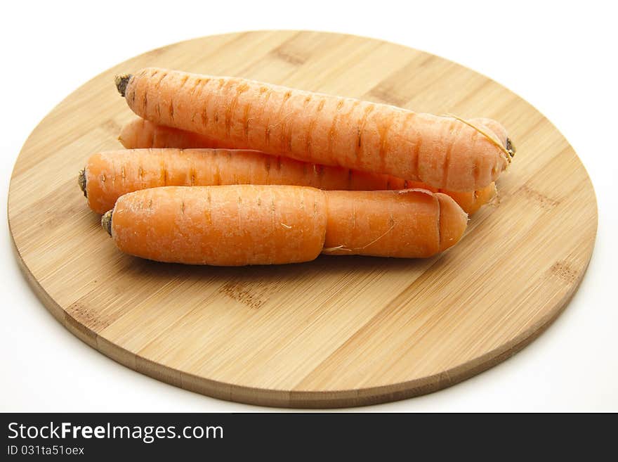 Carrots on round wood plate