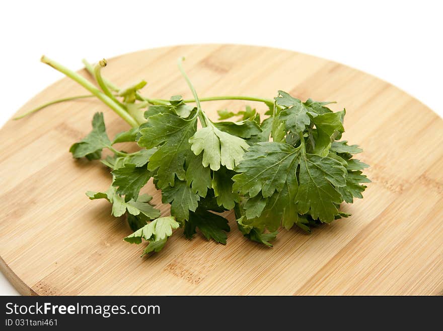 Parsley on round wood plate