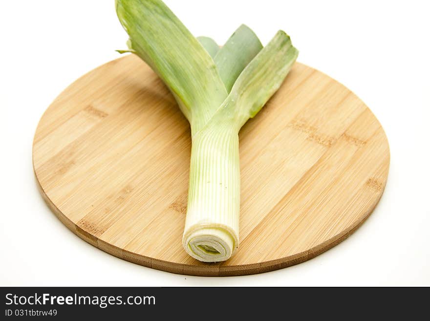 Leek on round wood plate