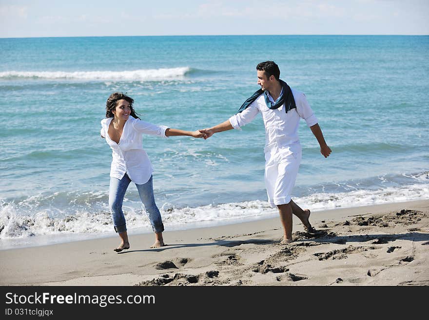 Happy Young Couple Have Fun At Beautiful Beach