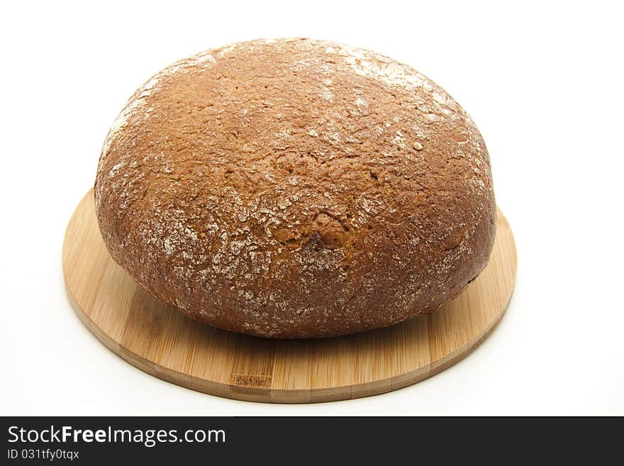 Round wheat bread onto wood plates. Round wheat bread onto wood plates