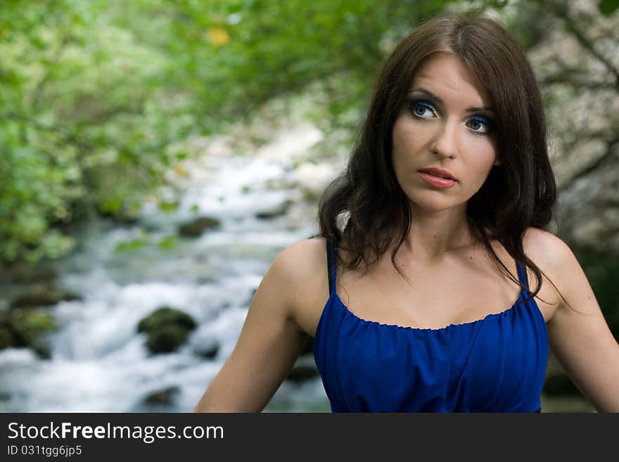 Beauty woman on rock river