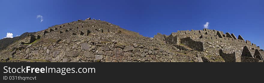 Low wide panorama view of part of Machu Picchu ruins and terraces. Low wide panorama view of part of Machu Picchu ruins and terraces