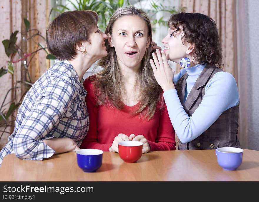 Two women share secrets with a friend