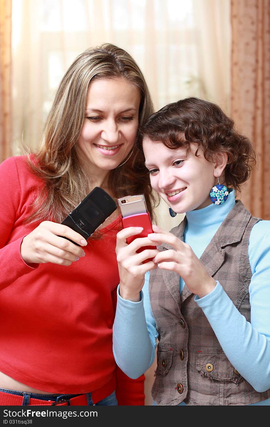 Two girls with mobile phones