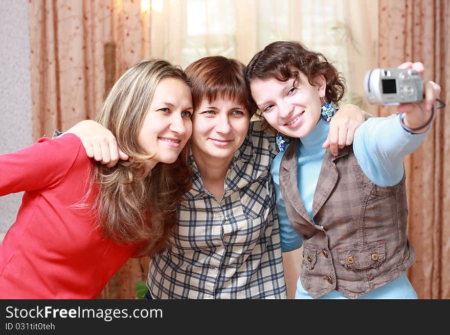 Three women photographing themselves