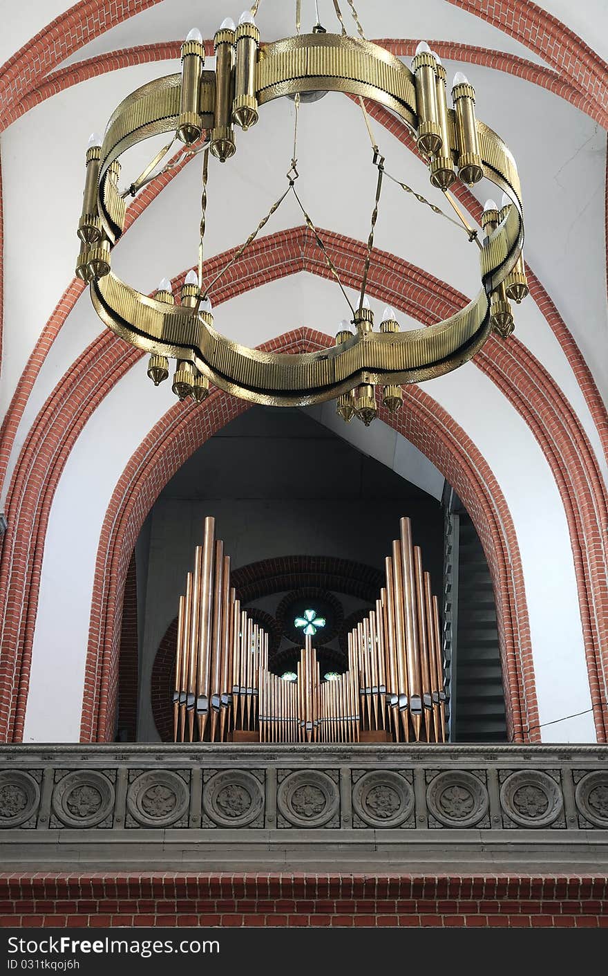 Church organ and lamp in a small city church. Copper pipes, gothic church. Church organ and lamp in a small city church. Copper pipes, gothic church