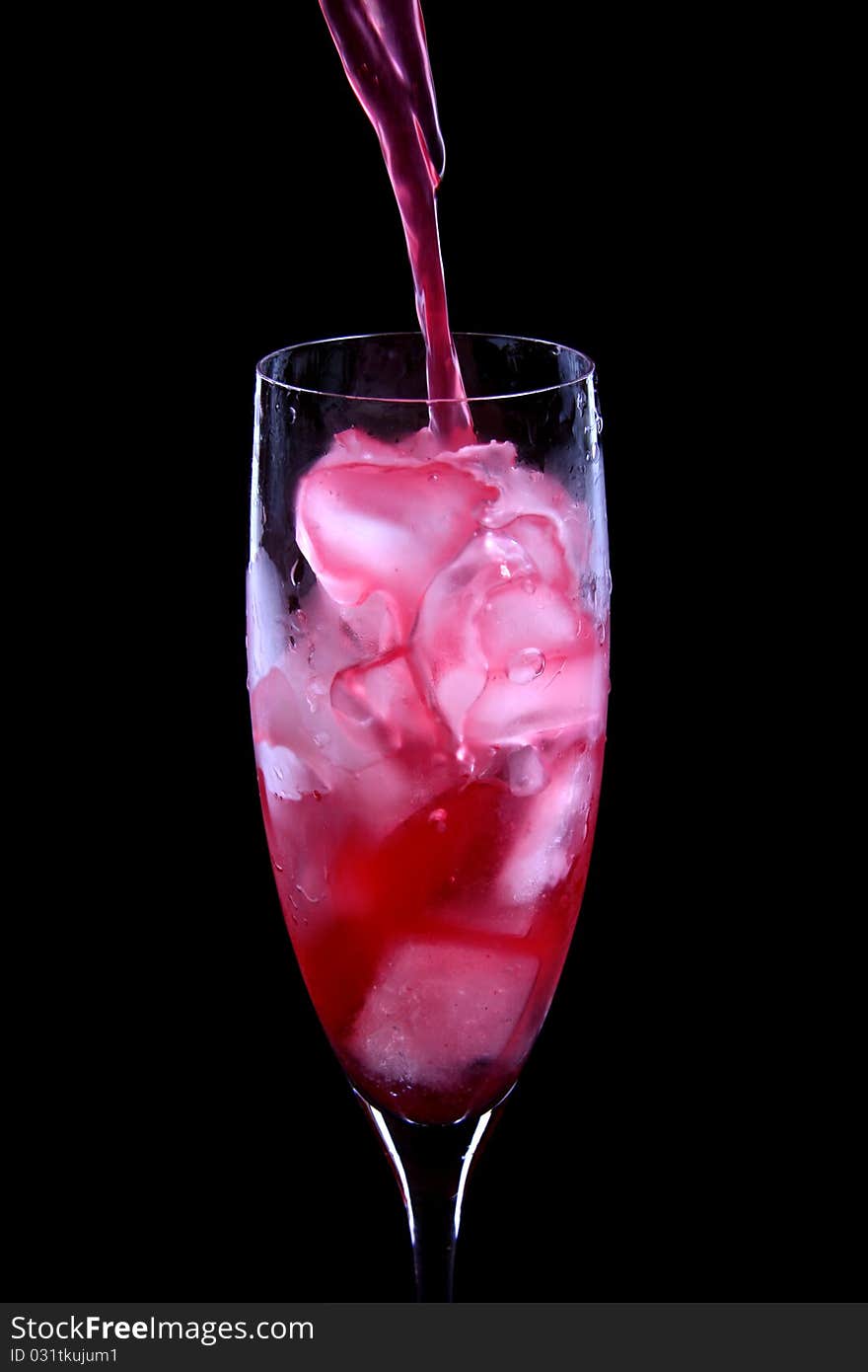 Red Cocktail Being Poured Into A Glass