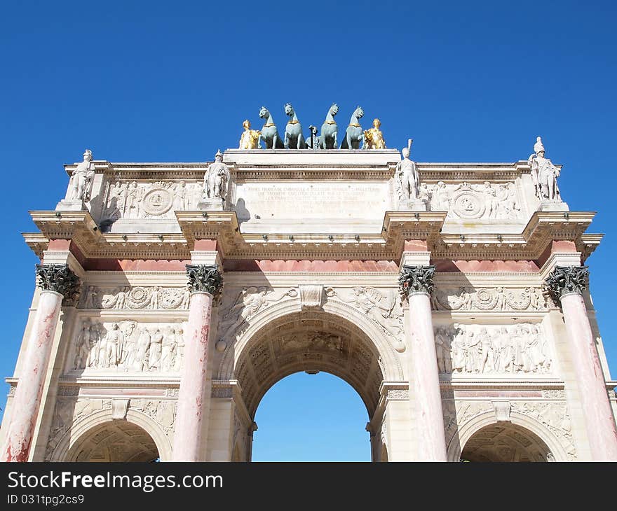 Arc de Triomphe du Carrousel with blue sky in Paris, France. In front of Louvre museum.