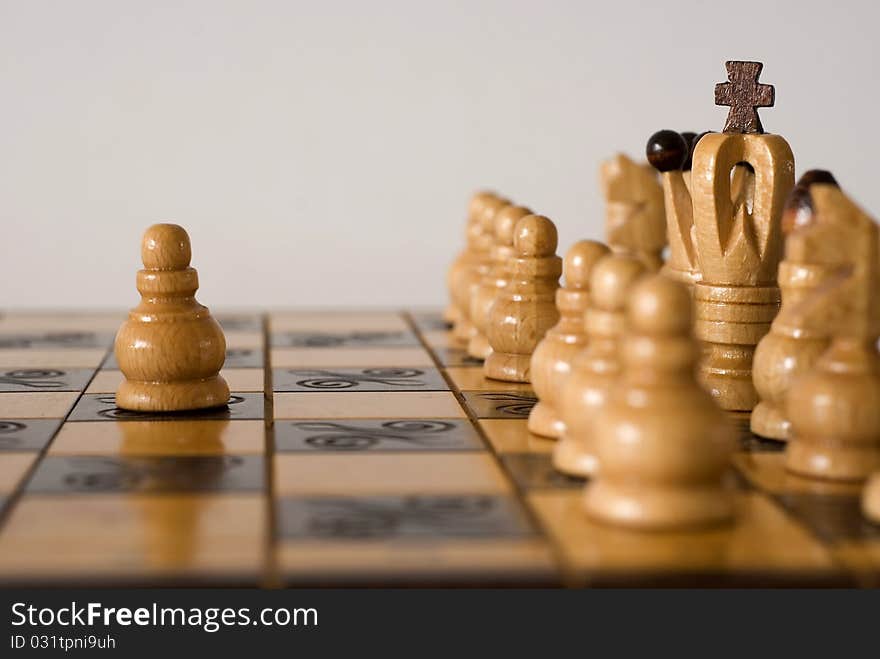 Figures of chess on the chessboard on the white background. Figures of chess on the chessboard on the white background