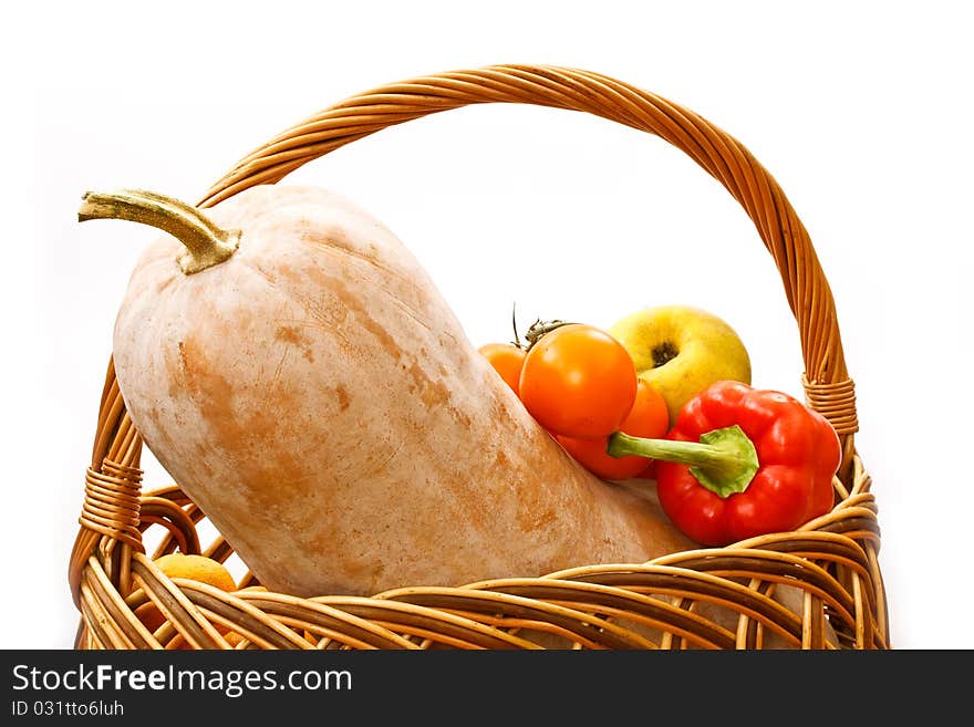 Pumpkin and harvest in a basket on a white background. Pumpkin and harvest in a basket on a white background