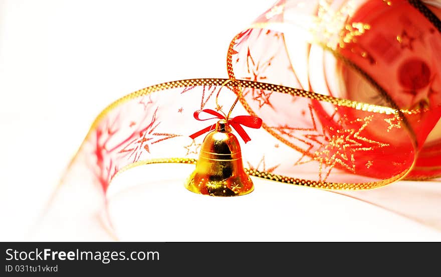 Christmas bell toy with red ribbon on white