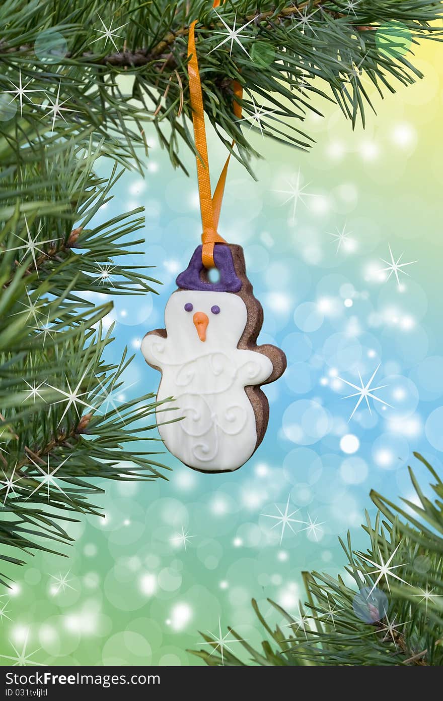 Christmas theme. Beautiful postcard. Christmas Gingerbread snowman on the fir-tree. Christmas theme. Beautiful postcard. Christmas Gingerbread snowman on the fir-tree