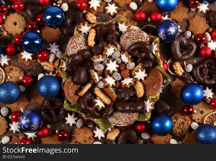 Still-live with some christmas cookies, cinnamon stars, chocolate and nuts. Still-live with some christmas cookies, cinnamon stars, chocolate and nuts