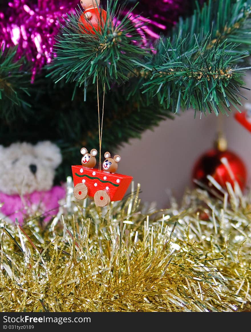 Wooden christmas trinket hanging from a fir tree. Wooden christmas trinket hanging from a fir tree.