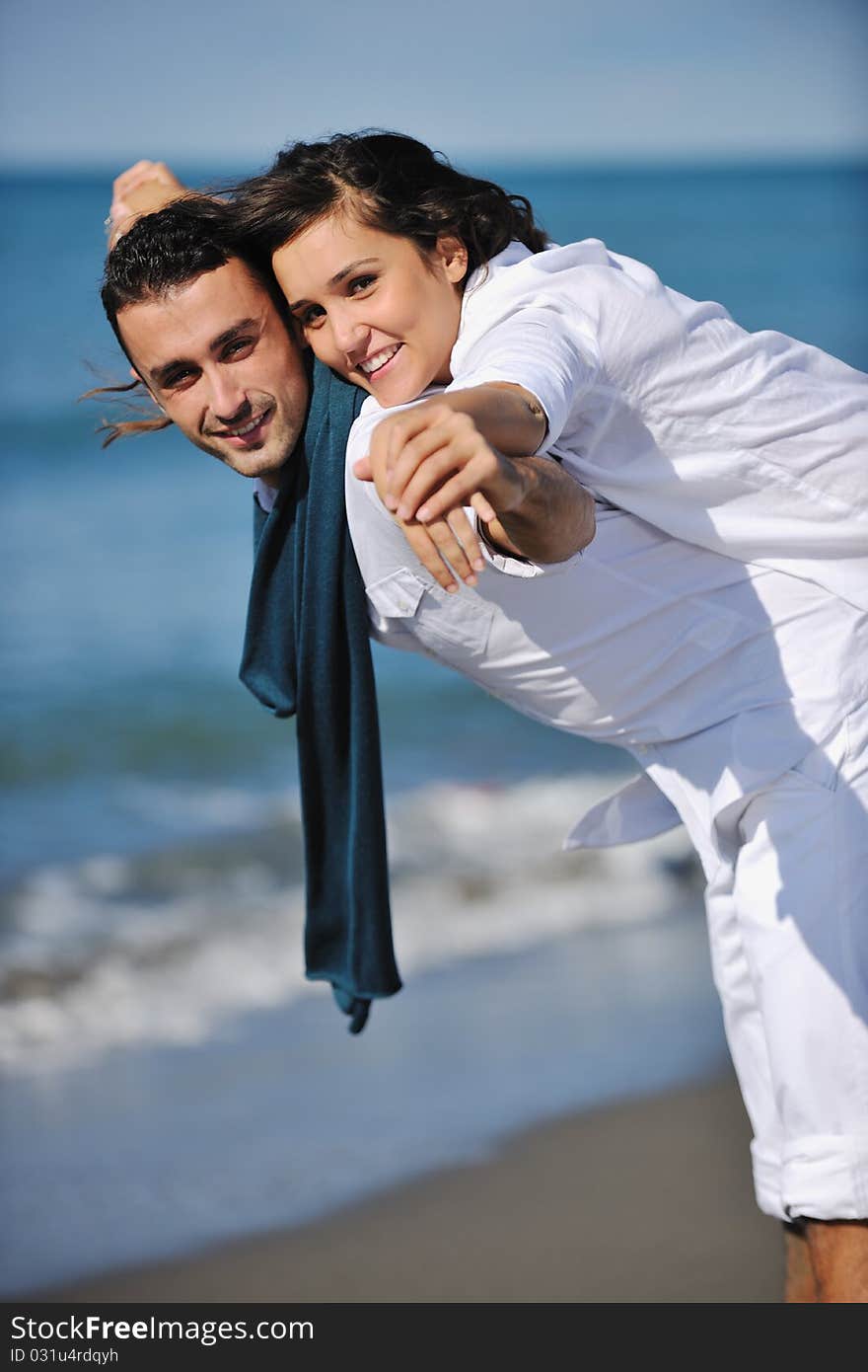 Happy young couple have fun at beautiful beach