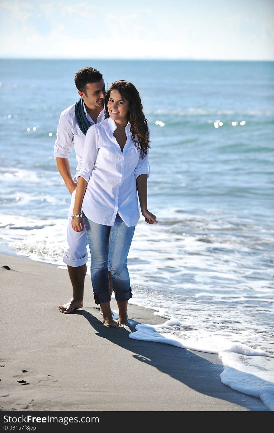 Happy Young Couple Have Fun At Beautiful Beach