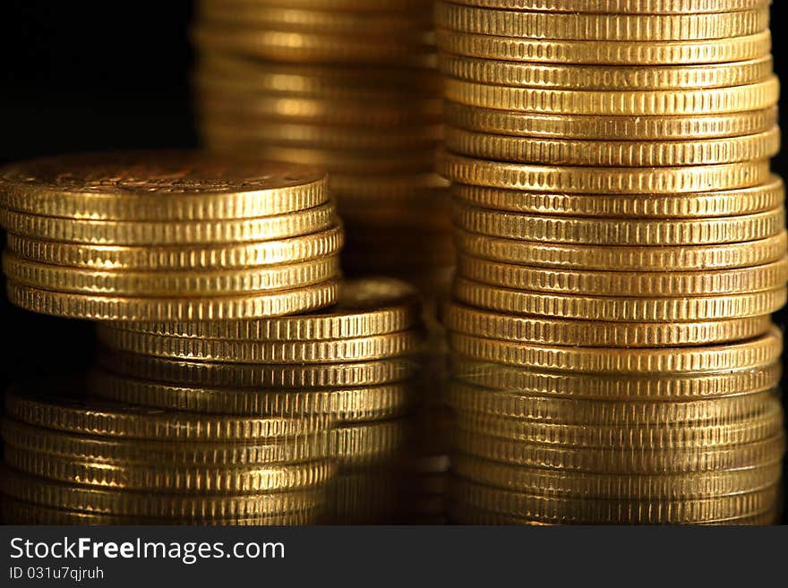 Golden coins on black background