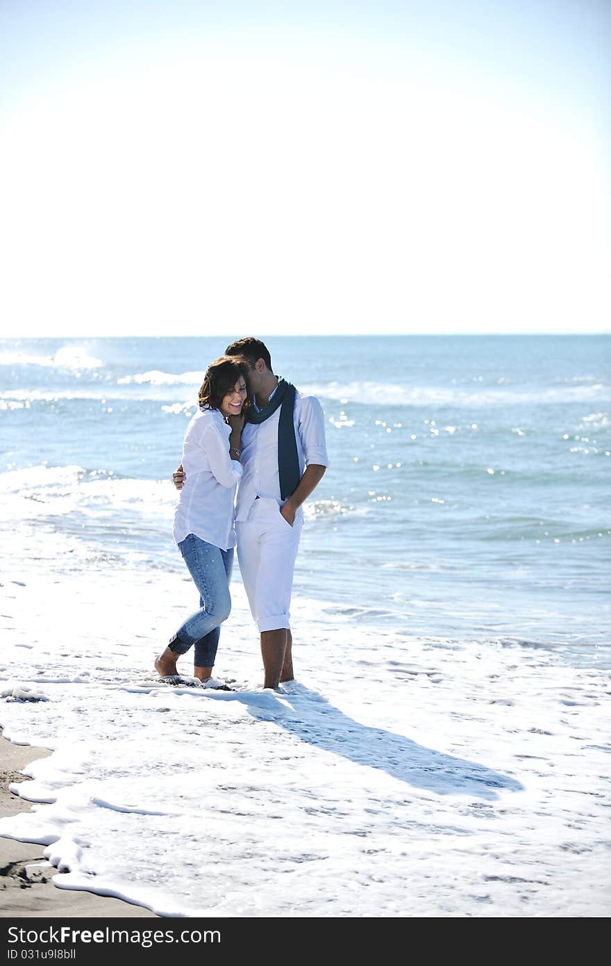 Happy young couple in white clothing have romantic recreation and fun at beautiful beach on vacations. Happy young couple in white clothing have romantic recreation and fun at beautiful beach on vacations