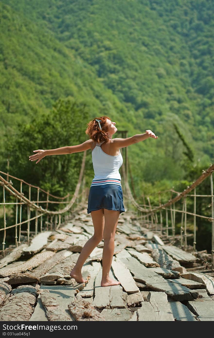 Girl on a mountain bridge