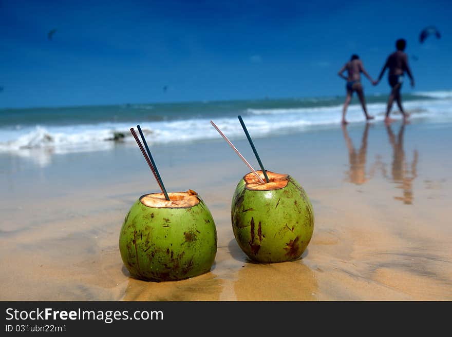 Coconut cocktail on beach sand