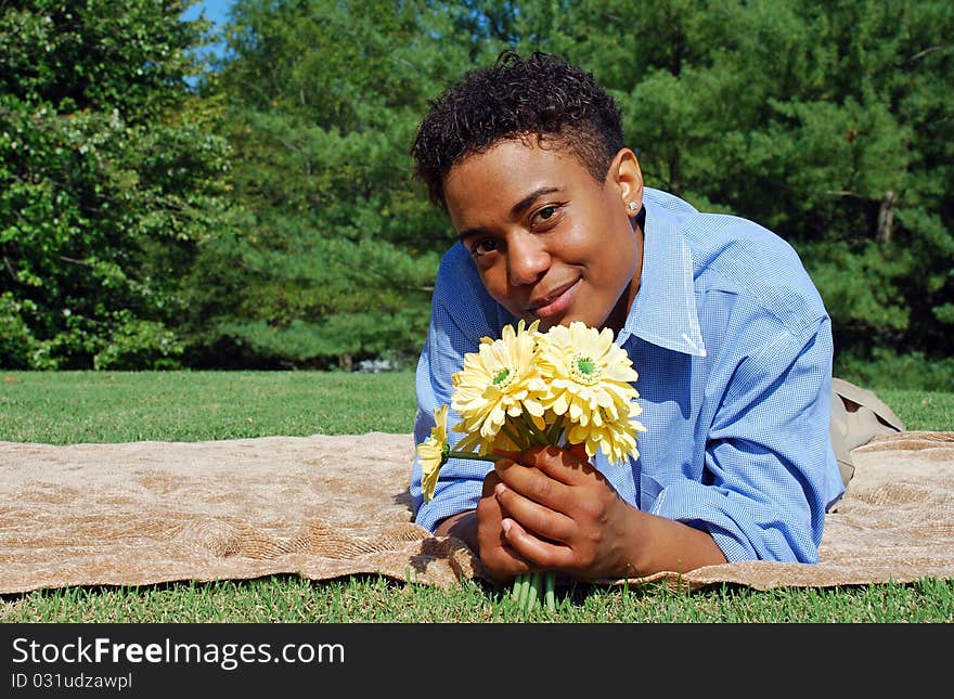 A woman holds a bouquet of yellow flowers. A woman holds a bouquet of yellow flowers.