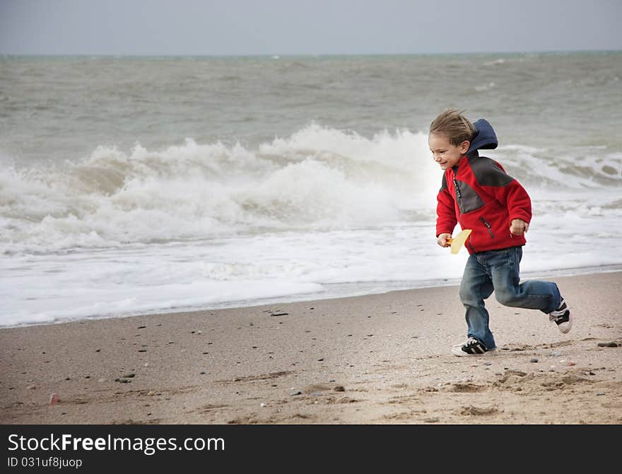 Happy Boy Running On Beach