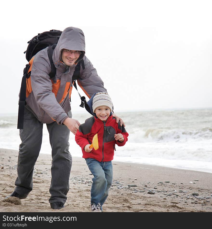 Father and son playing on beach. Father and son playing on beach