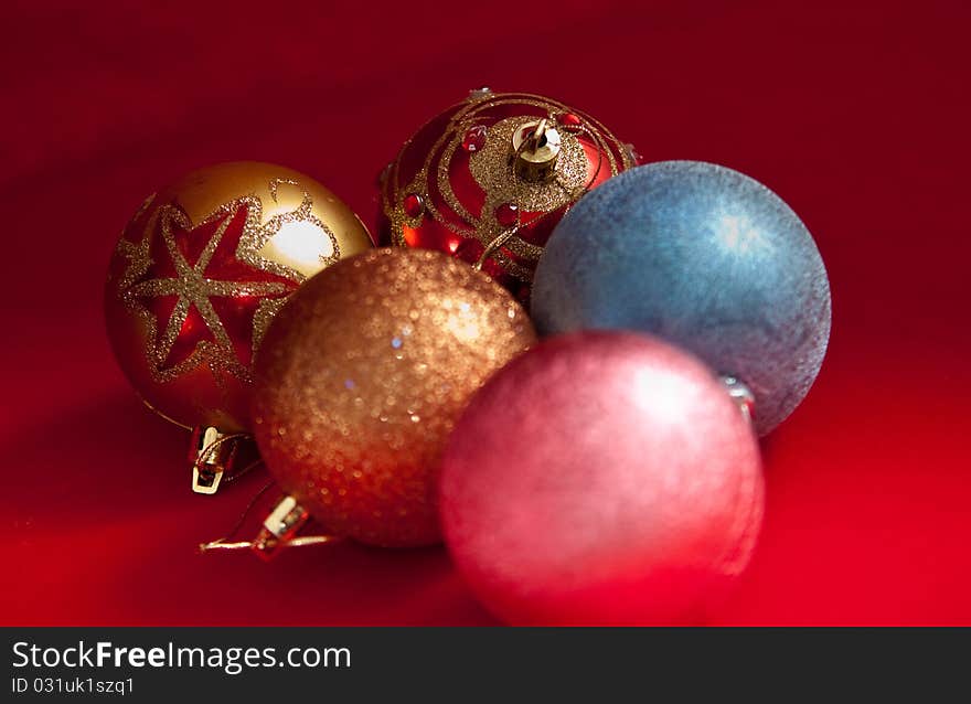 Varicoloured christmas balls on red  background  . Varicoloured christmas balls on red  background  .