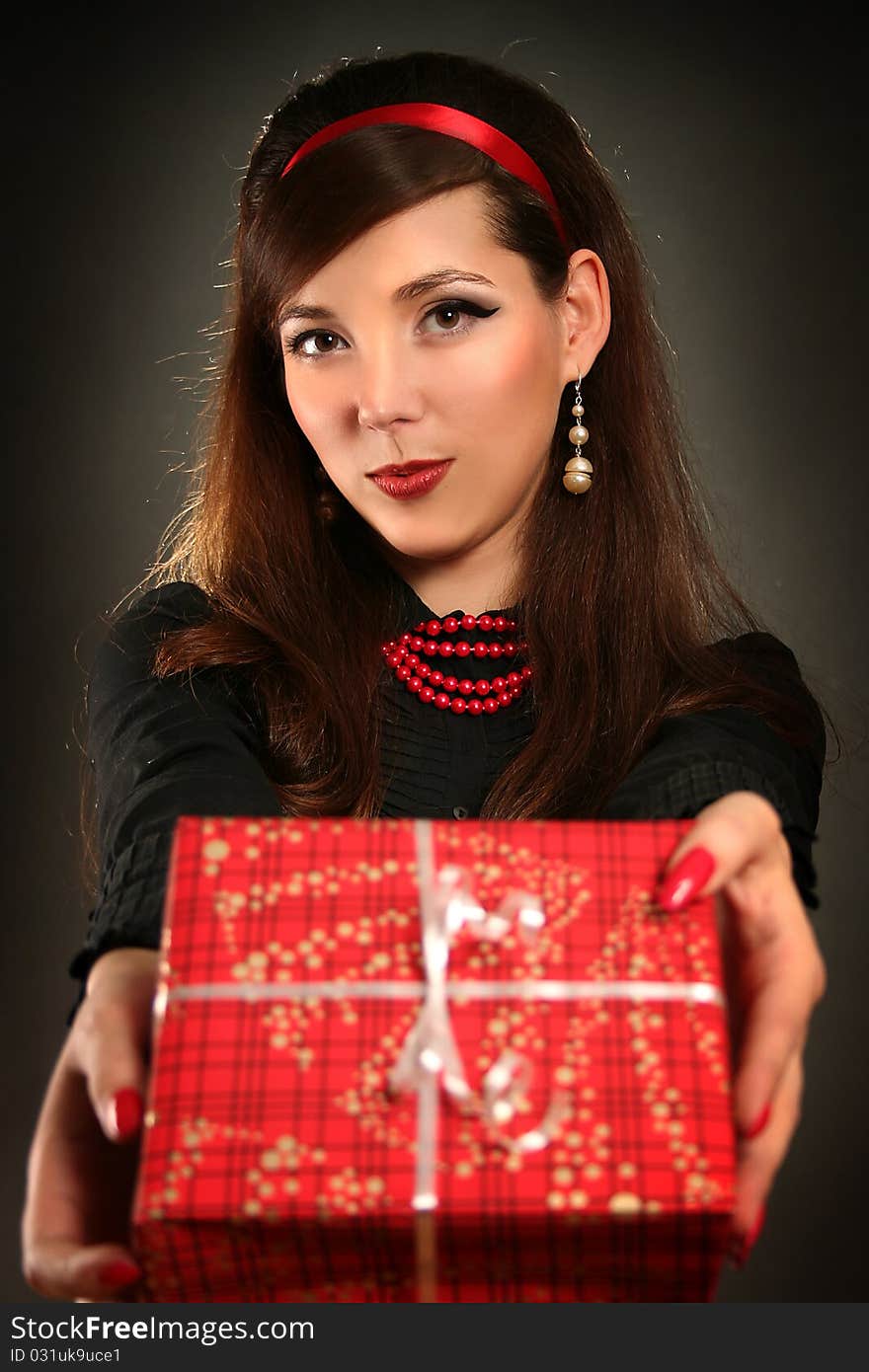 Beautiful retro woman with red present. Beautiful retro woman with red present